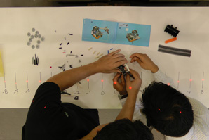 Overhead view of two human factors interns collaboratively building a Lego set